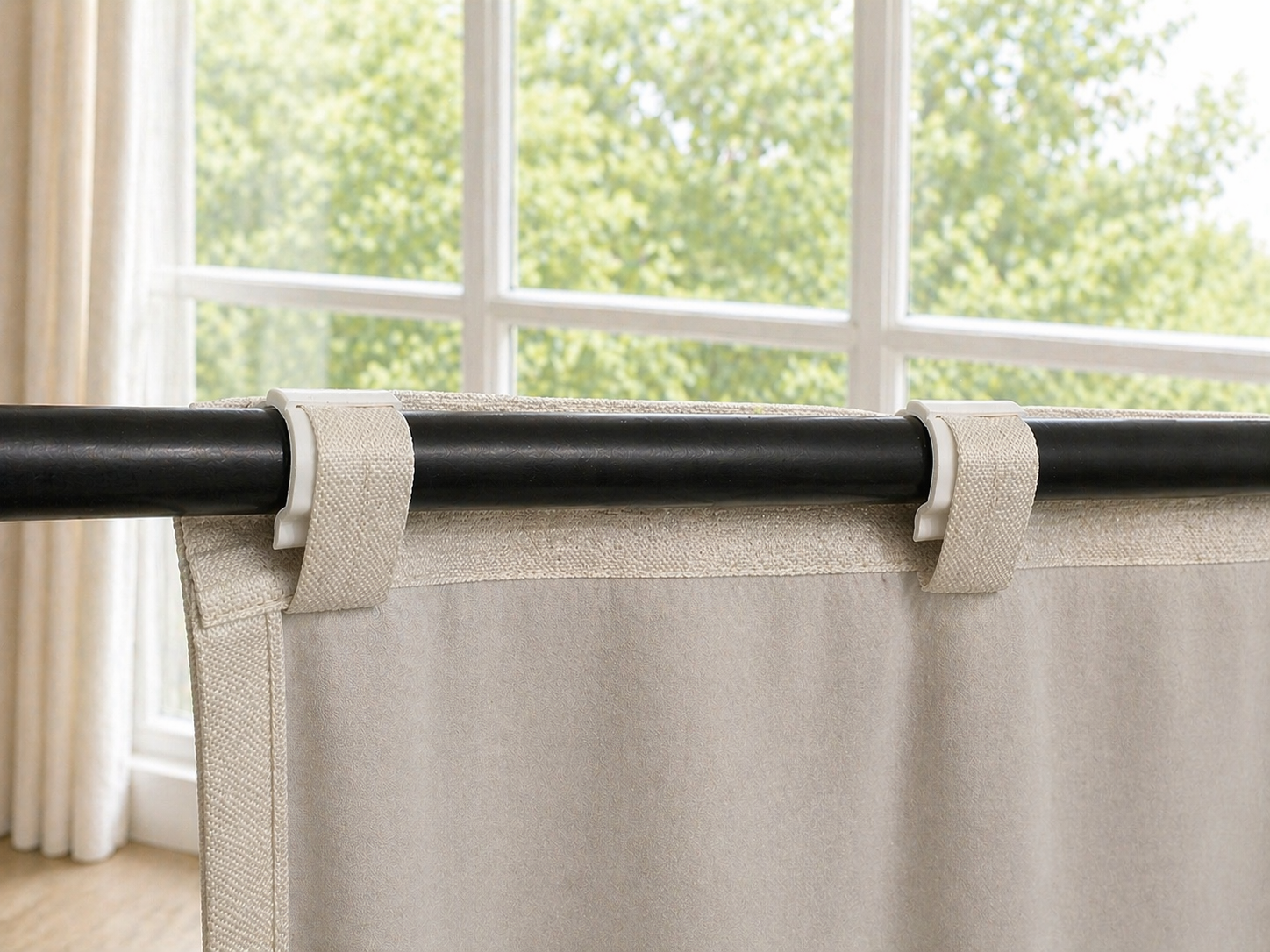 SilkSlide clips gripping curtain back tabs on a rod — smooth glide guaranteed