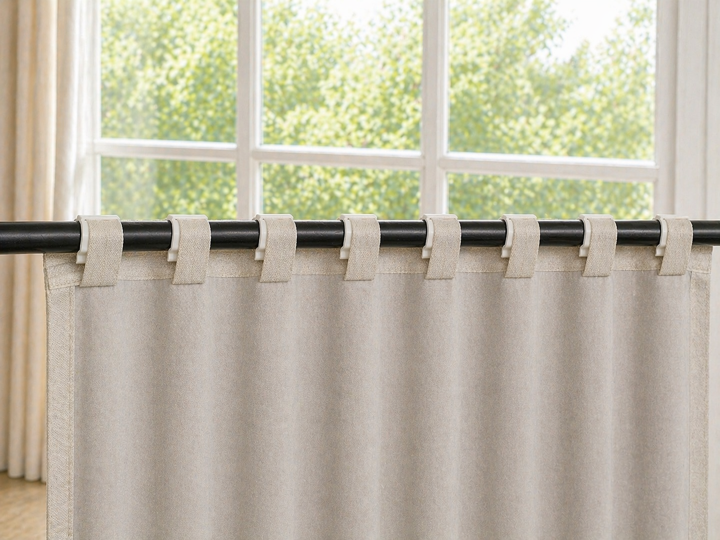 8 SilkSlide clips evenly spaced on curtain rod — perfect pleat spacing