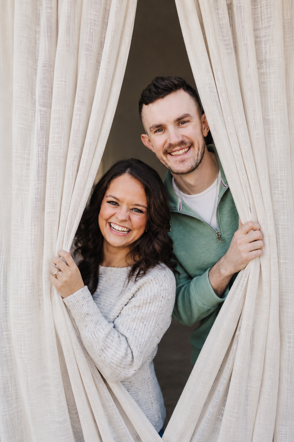 Austin and Brynn, founders of SilkSlide, peeking through their curtains in Austin TX